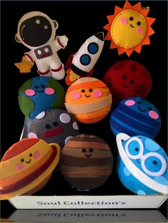 an assortment of stuffed toys sitting on top of each other in front of a black background