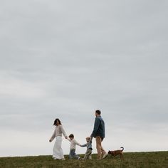 a family walking their dog in a field