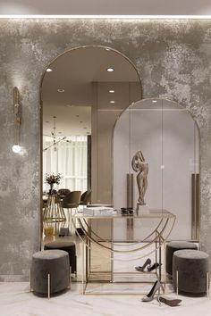 an elegant dining room with mirrored table and stools in front of a large mirror