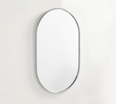 an oval mirror mounted to the side of a wall