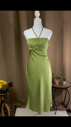 Midi dress Halter neck tie fastening Zipper fastening on the side 97% polyester 3% spandex Model is wearing a size small Color- green Solid Color Spring Dresses For Night Out, Spring Solid Color Dresses For Night Out, Elegant Light Green Maxi Dress, Elegant Olive Party Dress, Green Knee-length Dress For Brunch, Green Maxi Dress For Date Night, Fitted Light Green Maxi Dress For Party, Fitted Olive Elegant Maxi Dress, Elegant Light Green Fitted Maxi Dress