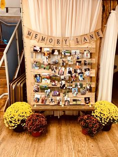 a memorial display with flowers and pictures on it