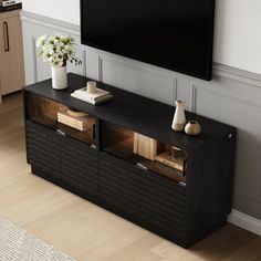 an entertainment center with a flat screen tv mounted on the wall