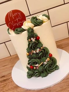 a christmas tree shaped cake on top of a white plate with red and green decorations