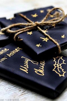 three black and gold christmas cards tied with twine