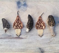 four different types of beaded animal heads on a wooden surface, with one bird's head in the middle