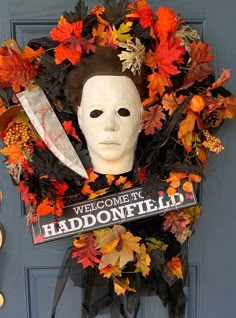 a halloween wreath with a mask and knife