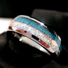 a wedding band that has been made to look like it is decorated with blue and red stones