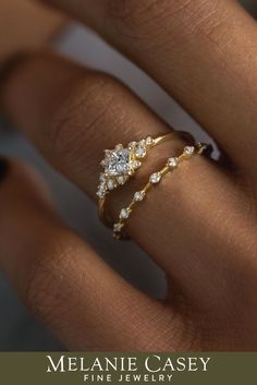 a woman's hand with two gold rings on it and the words melanie casey fine jewelry