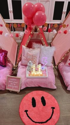 a bedroom decorated in pink and red with balloons