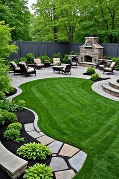 an outdoor patio and fire pit surrounded by lush green grass