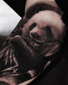 a man's arm with a panda bear tattoo on it