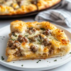 a slice of sausage and cheese pizza on a plate