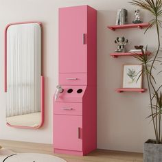 a pink cabinet in the corner of a room with a mirror and potted plant