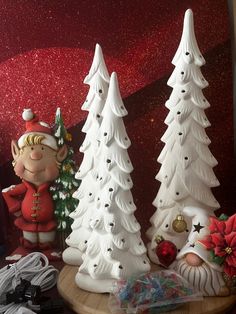 two white christmas trees on a wooden table