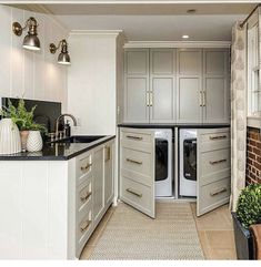 a kitchen with an open door leading to the washer and dryer in it