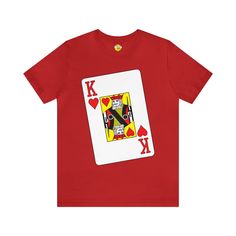 Step into the deck with our "King of Hearts" Big Face Tee. This eye-catching shirt features a bold illustration of the King of Hearts playing card, making it a standout choice for poker enthusiasts and card game lovers. Crafted from Bella Canvas 3001 fabric, it ensures both comfort and style. Elevate your wardrobe with this unique tee that combines a touch of royalty with the thrill of the game. Key Features: Made from Bella Canvas 3001 for softness. Striking King of Hearts illustration. Perfect Red Heart-shaped Top With Graphic Print, Valentine's Day Graphic Tee Shirt With Graphic Print, Valentine's Day Short Sleeve Shirt With Graphic Print, Valentine's Day Graphic Print Short Sleeve Shirt, Red Cotton Shirt For Valentine's Day, Valentine's Day Graphic Print Tops, Red Graphic Print T-shirt For Valentine's Day, Playing Card Shirt, Queen Of Hearts Shirt