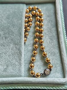 "Lower prices on our main website: https://discomarshmallow.myshopify.com Transport yourself to the opulent allure of the past with our 16-inch Ball Chain Necklace, a masterpiece that pays homage to the elegance of the Georgian and Art Deco periods. This necklace is a true embodiment of vintage charm and contemporary sophistication. At its heart, a brilliant cut 0.25 ct moissanite gleams with a brilliance that rivals the stars. The moissanite is securely nestled within a 14k blackened gold Georg Gold Round Diamond Necklace For Evening, Gold Diamond Necklace For Evening With Single Cut Diamonds, Luxury Jewelry With Round Beads For Evening, Luxury Evening Jewelry With Round Beads, Antique Yellow Gold Necklace With Diamond Accents, Formal Jewelry With Round Beads Chain, Gold Single Strand Jewelry For Evening, Single Strand Gold Jewelry For Evening, Luxury Chain Diamond Necklace For Anniversary