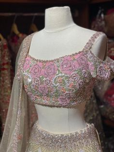 Green & pink lehenga heavily embellished in cut dana, crystal stone, sequins embroidery. Paired with a matching thread and sequins embroidered blouse with cold shoulder and net dupatta Fabric: Net Custom designed according to client measurements and color preference. Production and delivery time is 120 days! Glamorous Chinon Lehenga For Wedding, Party Wear Embroidered Fabric With Sequins For Receptions, Semi-stitched Hand Embellished Chinon Lehenga, Designer Hand Embellished Chinon Lehenga, Designer Wear Hand-embellished Lehenga, Party Wear Embellished Embroidered Fabric For Reception, Glamorous Sequined Lehenga In Chinon, Hand Embellished Semi-stitched Choli For Reception, Semi-stitched Hand Embellished Choli For Reception