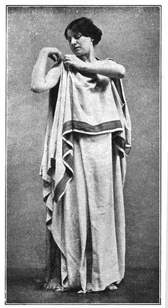 an old black and white photo of a woman dressed in roman garb with her arms crossed