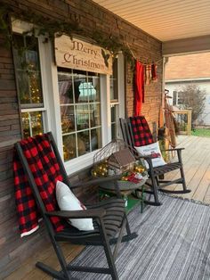 two rocking chairs on the front porch decorated for christmas with plaid blankets and garlands