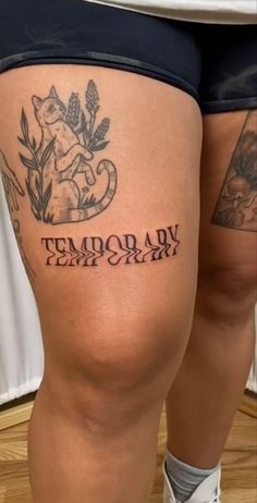 a woman's thigh with tattoos on her legs and the words temporary army written in cursive font