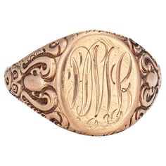 Lovely antique Victorian signet ring (circa 1880s to 1900s), crafted in 10 karat rose gold. From what we can decipher, the center mount is engraved with the initials "PML" The side shoulders feature a pretty scrolling design that terminates to the oval mount. The saddle of the ring is low and curves to the shape of the finger, rising 1.5mm from the finger (0.05 inches). The ring is in good condition with patina and wear evident. We have not cleaned the ring in order to preserve the patina and collector value. Particulars: Weight: 5.8 grams Stones: N/A. Size & Measurements: The ring is a size 11 (sizable). The mount measures 16mm in length (0.62 inches) and 12.5mm wide (0.49 inches), rising 1.5mm from the finger. Metal & Hallmark: 10 karat rose gold. The ring is not hallmarked though it has Luxury Vintage Engraved Initial Ring, Luxury Victorian Gold Signet Ring, Luxury Classic Round Engraved Ring, Luxury Engraved Oval Cabochon Jewelry, Oval Signet Ring, Vintage Fine Jewelry, Vintage Victorian, Antique Victorian, Signet Ring