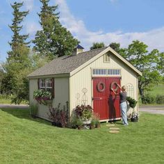 two people standing in front of a shed