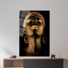 a woman's face with gold jewelry and earrings on it in front of a black background