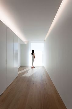 a woman is standing in an empty room