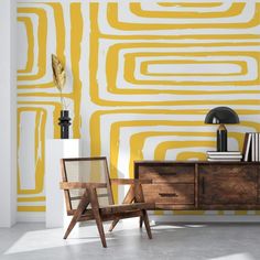 two chairs and a table in front of a wall painted with yellow paint on it