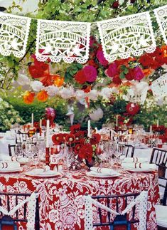 the table is set with red and white linens, lace doily hanging from the ceiling