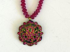 Antique Rakodi pendant from South India on a ruby necklace Gold, rubies, diamond, emerald; necklace facetted rubies Diameter pendant 32 mm Weight 27,16 grams 44cm long A rakodi is a South Indian hair ornament The stones are fixed in kundan setting Perfect condition This is only a part of my collection, for more items please visit my website  www.m-beste.com There you will find a large selection of jewelry, figurines, textiles and other objects from India and Tibet. * * * Shipping  * * * All inte Ruby Round Beads Temple Jewelry Necklace, Temple Style Ruby Beaded Necklaces, Traditional Round Faceted Jewelry, Traditional Faceted Jewelry For Gifts, Traditional Ruby Round Pendant Necklace, Emerald Necklace With 17 Jewels For Festivals, Ruby Gemstone Temple Jewelry Necklace, Festival Ruby Pendant Necklaces, Ruby Round Pendant Necklace