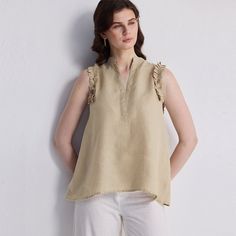 Our Sleeveless Hemp Top with ruffles combines effortless elegance with sustainable style. Made from soft, breathable hemp fabric, this top features delicate ruffles along the neckline, adding a touch of feminine charm. The sleeveless design ensures comfort and versatility, perfect for layering or wearing on its own. Ideal for warm days or casual outings, this top offers a blend of style and eco-consciousness, making it a must-have for your wardrobe. Office Blouse, Top With Ruffles, Pleated Blouse, Hemp Fabric, Sustainable Style, Ruffle Shorts, Neutral Beige, Chiffon Blouse, Shop Blouses