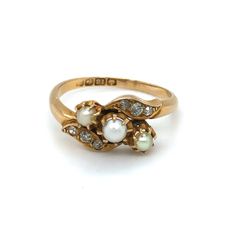 This superb 18k gold ring is set with a trio of pearls flanked by six old cut diamonds. It dates from the early 20th century (1911). The ring has an unusual crossover design and is a very chic, easy to wear piece for your collection. Details Ring size: UK Q Weight: 3.7g Age: Edwardian Materials 18k gold (hallmarks 18k, Birmingham and 1911), pearl and diamond   Condition Notes Good used condition in line with age-related wear. Pearl Rings Vintage, Edwardian Ring, Antique Jewelry Rings, Edwardian Jewelry, Pearl And Diamond Ring, 18k Gold Ring, Bling Rings, Pretty Rings, Dream Jewelry