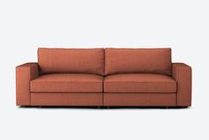 a brown couch sitting on top of a white floor