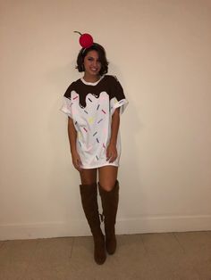 a woman standing in front of a white wall wearing a t - shirt with an apple on it