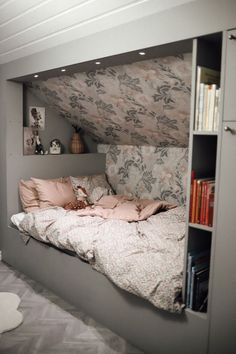 a bedroom with a built in bed and bookshelf