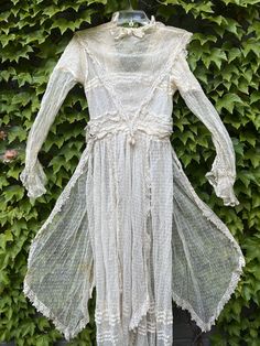 "A beautiful genuine Edwardian Era cream dotted Swiss wedding dress. This amazing dress is a cream netted dotted Swiss with lace trim with V bodice overlay accented with three crocheted covered teardrop dangles, long slim sleeves with lace trimmed ruffled cuffs, tiered ruched waistband and side panels  framing the long full skirt. The back has snaps closures to both the lining and the outer bodice with an ivory satin ribbon rosette accent.  From a Cincinnati estate  Excellent vintage condition, Swiss Wedding, Edwardian Wedding Dress, 1940s Wedding Dress, Edwardian Wedding, Bridal Gowns Vintage, Victorian Wedding, Etsy Wedding Dress, Maxi Dress Wedding, Wedding Gowns Lace