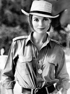 black and white photograph of a woman wearing a cowboy hat with her hands in her pockets