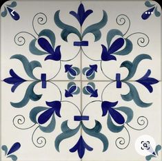 a blue and white tile design with swirls