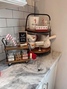 the kitchen counter is decorated with christmas decorations and baking utensils, including mugs