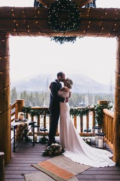 a bride and groom kissing on the porch at their winter wedding in tellicoa, colorado