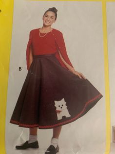 a woman in a red shirt and black skirt with a white dog on the front