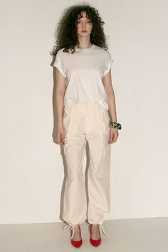 Loosely tailored cargo pant in a soft yet structured cotton. Straight leg with tie at ankle, cinch for a more tapered silhouette. Side pockets and oversized patch pockets above knee. Made in New York City. Fabric is 100% cotton. Avery is 5'10", bust 31", waist 24", hip 35", and is wearing a size S. Utility Cotton High-waisted Parachute Pants, Spring Relaxed Fit Cargo Pants With Multiple Pockets, Cotton Parachute Pants With Multiple Pockets For Work, Spring Workwear Cargo Pants With Patch Pockets, Cotton Cargo Pants With Pockets For Workwear, High-waisted Cotton Cargo Pants, Spring Relaxed Fit Cargo Pants With Patch Pockets, Spring Relaxed Fit Cargo Pants With Pockets, Spring Workwear Parachute Pants With Cargo Pockets