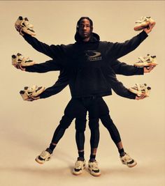 two people standing with their hands in the air and holding up pairs of tennis shoes