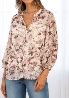 For the romantic at heart, our sheer floral print blouse is full of dreamy details. With long voluminous sleeves, pretty lace trim detail across the front, and delicate clip dot details throughout. A stunning style that pairs effortlessly with denim. FINAL SALE Floral print Relaxed fit Long voluminous sleeve Elastic wrist cuff Split neckline with ties Self-covered button front Lace trim detail across the front Clip dot detail throughout Sheer Removable lining Peasant top Model is 5'9, wearing a Spring Feminine Blouse With Lace Trim, Feminine Lace Trim Blouse For Spring, Spring Lace Blouse With Lace Trim, Lace Floral Print Tops For Daywear, Lace Tops With Floral Print For Daywear, Feminine Spring Blouse With Lace Collar, Feminine Lace Collar Blouse For Spring, Elegant Lace Blouse With Floral Print, Feminine Blouse With Lace Collar For Spring