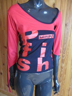 Rare Punky Fish  Tee-shirt from the 90s, mainly black with red pieces, the Punky Fish logo is on the front.  Dimensions: Size: 8 UK. Chest: 28 Inches. Length: 20 Inches. Made by PUNKY FISH Red Punk Top With Graphic Print, Stretch Graphic Print Top For Alternative Fashion, Stretch Tops With Graphic Print For Alternative Fashion, Red Stretch Tops With Graphic Print, Red Stretch Top With Graphic Print, Punk Style Fitted Screen Print Tops, Red Punk Tops With Letter Print, Fitted Punk Style Screen Print Tops, Punk Style Red Tops With Letter Print