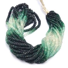 green and black beaded necklace on white background