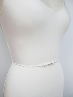 "This sparkly super skinny bridal belt is made with Swarovski crystals beaded on a 1/8\" wide ribbon. The crystal part of the belt measures 26\" long with the center detail measuring 3\" long. Finished with the 1/4\" satin ribbon ties in the back. The entire sash measures 150\" long. Available in gold, silver or rose gold finish. - For the photo of the ribbon color options please take a look here: https://www.etsy.com/listing/225025505/satin-ribbon-swatches-ribbon-color?ref=shop_home_active_92 - Fitted Rhinestone Belts For Party, Fitted Silver Crystal Bridal Belt, Silver Fitted Bridal Belt For Formal Occasions, Fitted Silver Bridal Belt With Sashes, Fitted Crystal Bridal Belt For Party, Silver Fitted Bridal Belt, Fitted Silver Bridal Belt For Bride, Silver Fitted Bridal Belt For Bridesmaid, Fitted Silver Bridal Belt For Bridesmaid